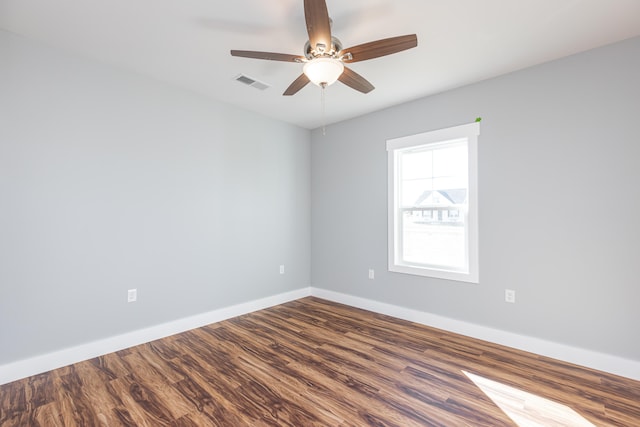 spare room with hardwood / wood-style floors and ceiling fan