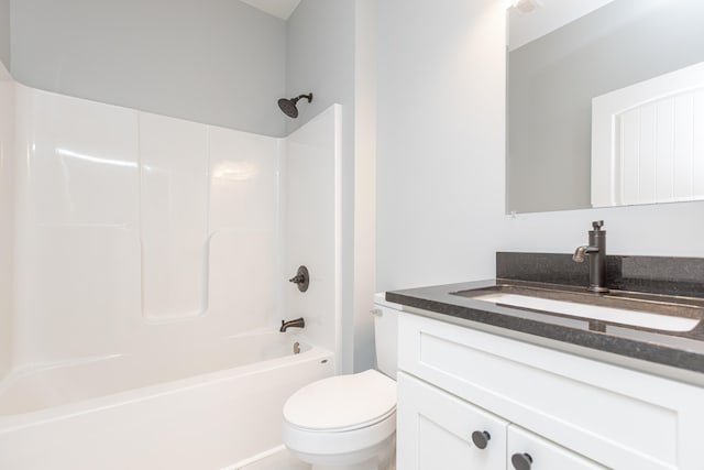 full bathroom featuring  shower combination, vanity, and toilet