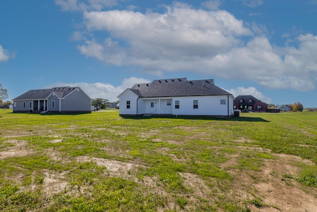 back of property featuring a lawn