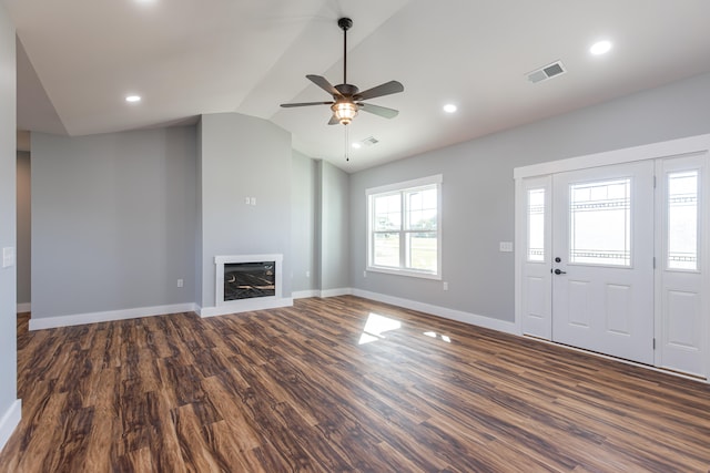 unfurnished living room featuring lofted ceiling, dark hardwood / wood-style flooring, and ceiling fan