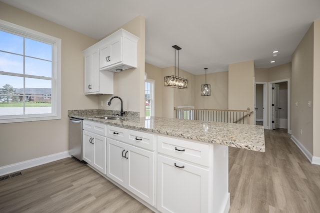 1814 Adkinson Dr, Richmond, KY 40475 - kitchen featuring a sink, stainless steel dishwasher, a peninsula, light wood finished floors, and baseboards