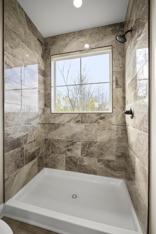 bathroom with a tile shower