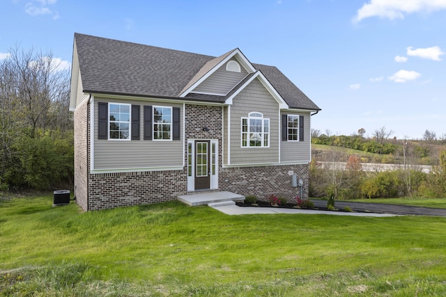 view of front of house featuring central AC and a front lawn