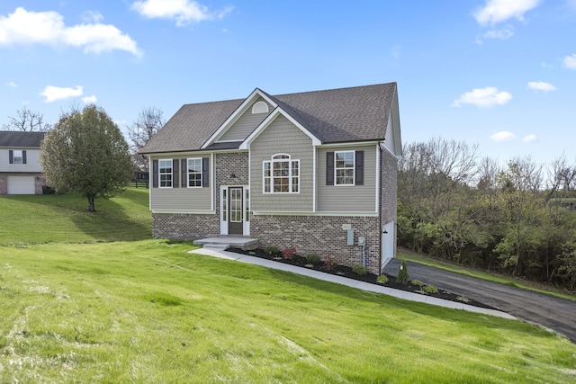 view of front facade with a front yard and a garage