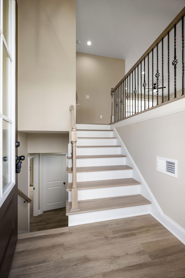 stairs with hardwood / wood-style flooring