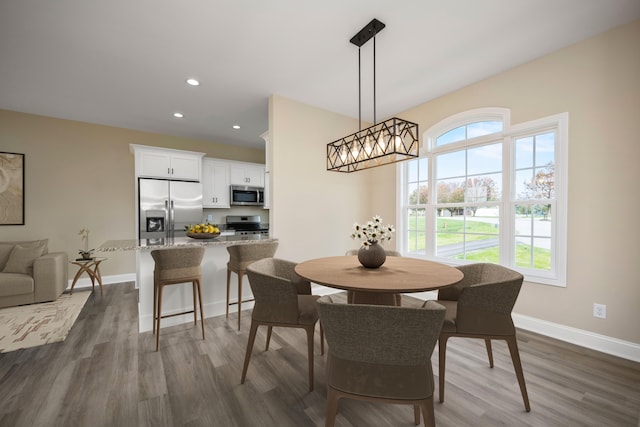 dining space with dark hardwood / wood-style floors