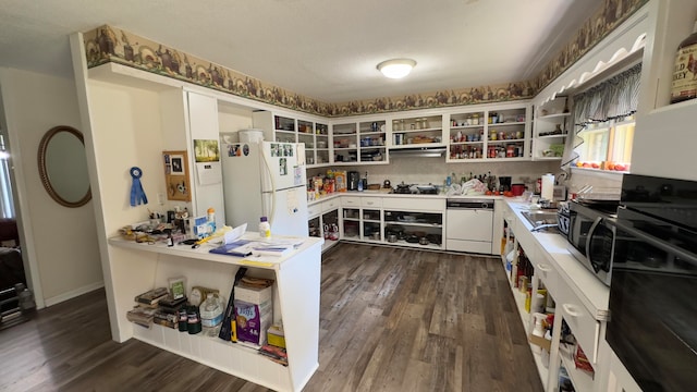 kitchen with white cabinets, white appliances, dark wood-type flooring, decorative backsplash, and a textured ceiling