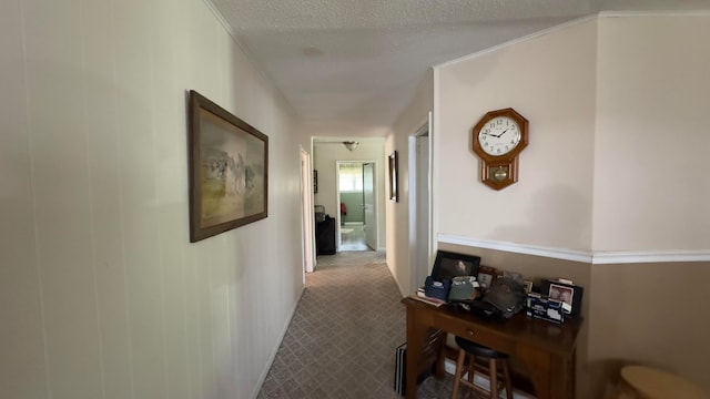 hallway with a textured ceiling and carpet