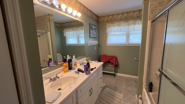 bathroom featuring tile patterned flooring, vanity, and a shower with shower door