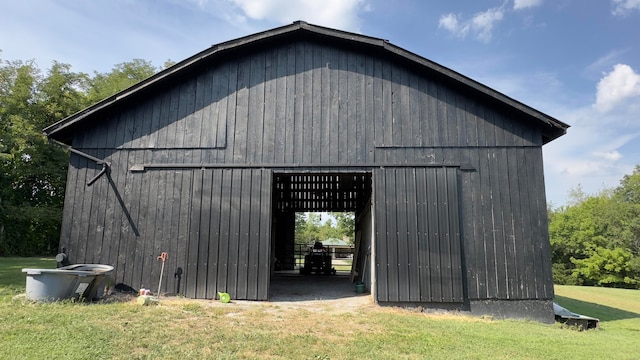 view of outbuilding featuring a lawn