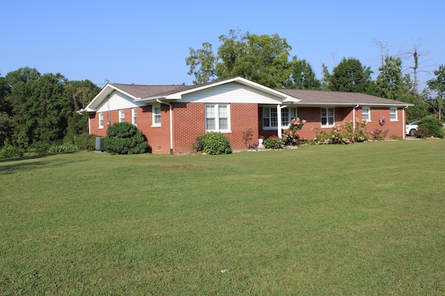 ranch-style home with a front lawn and central AC unit