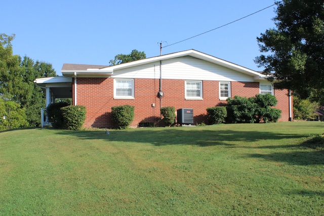 view of property exterior with central AC and a lawn