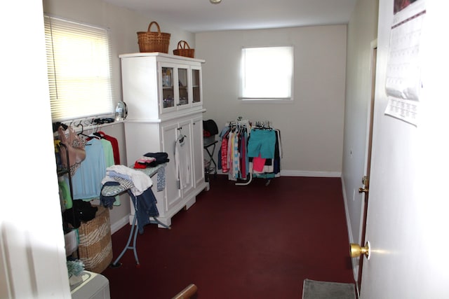 misc room with plenty of natural light and dark colored carpet