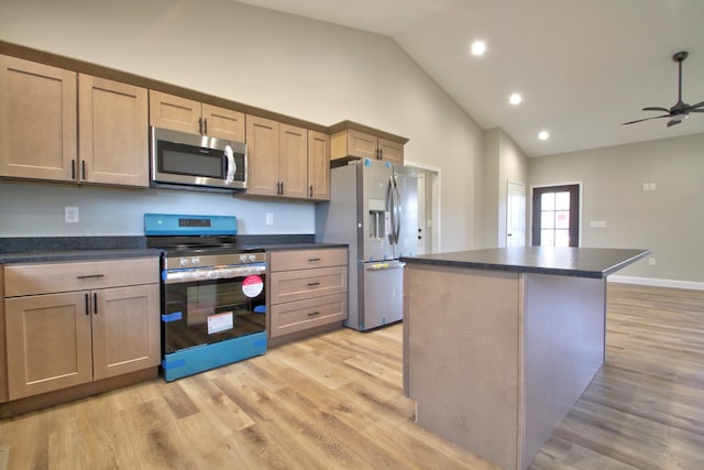 kitchen with light brown cabinetry, light hardwood / wood-style flooring, appliances with stainless steel finishes, a kitchen island, and ceiling fan