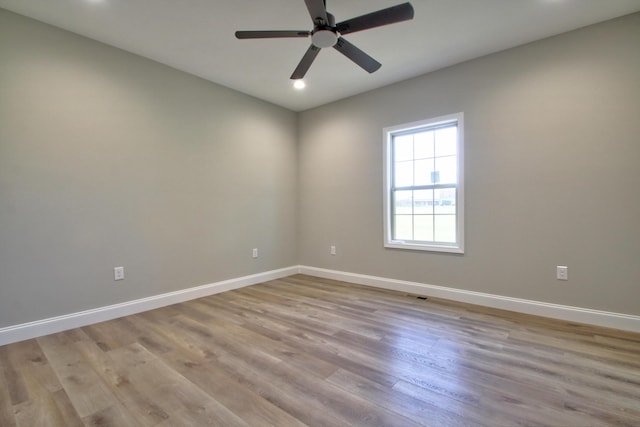 empty room with ceiling fan and light wood-type flooring