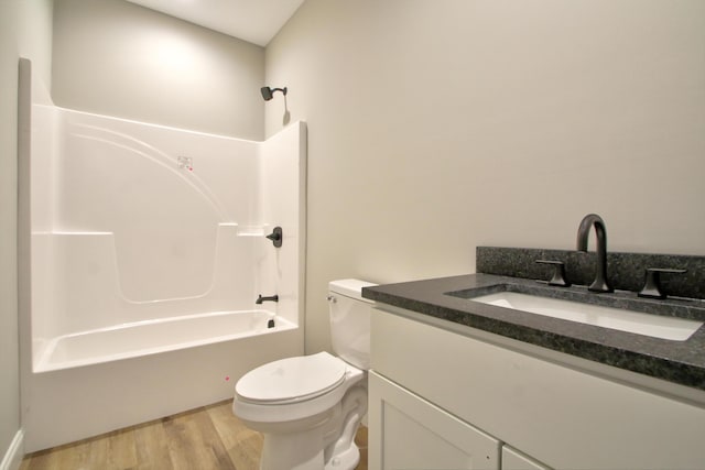 full bathroom with vanity, bathtub / shower combination, hardwood / wood-style floors, and toilet