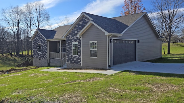 view of front of house featuring a garage, a sunroom, and a front yard