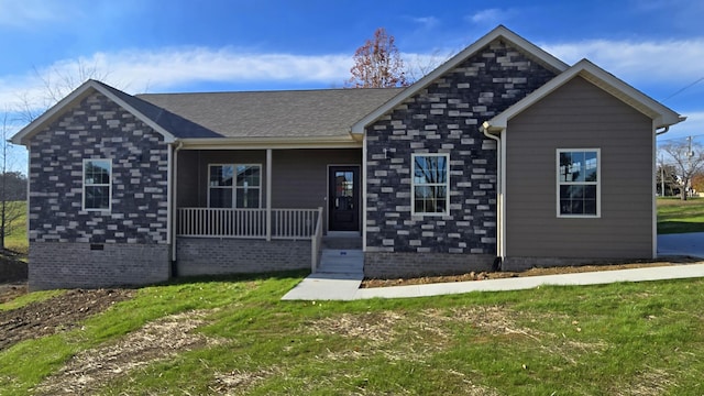 view of front of home with covered porch and a front yard