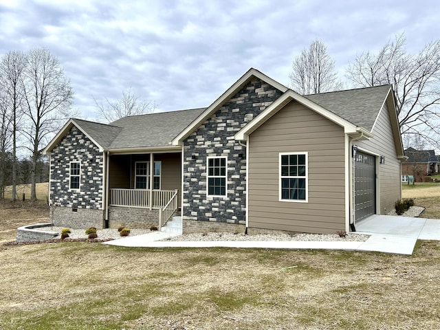 view of front of home featuring a garage, a front lawn, and a porch