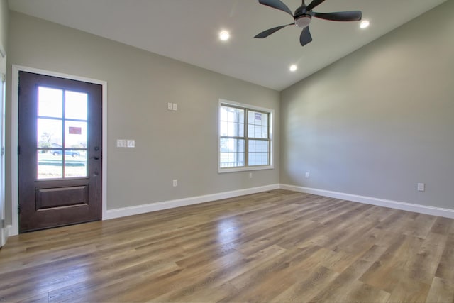 foyer with vaulted ceiling, ceiling fan, and light hardwood / wood-style flooring