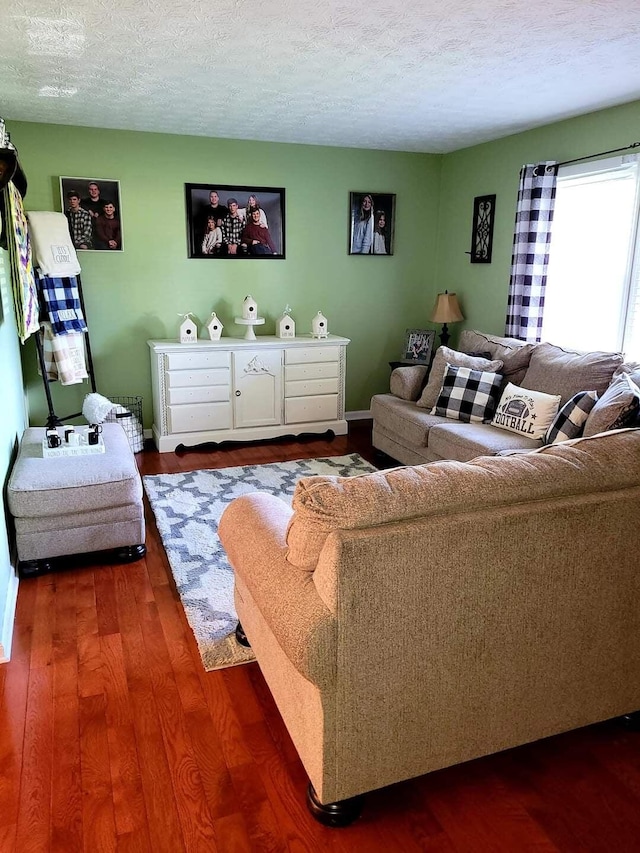 living room featuring a textured ceiling and dark hardwood / wood-style flooring