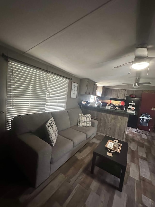 living room featuring ceiling fan, dark hardwood / wood-style floors, and sink