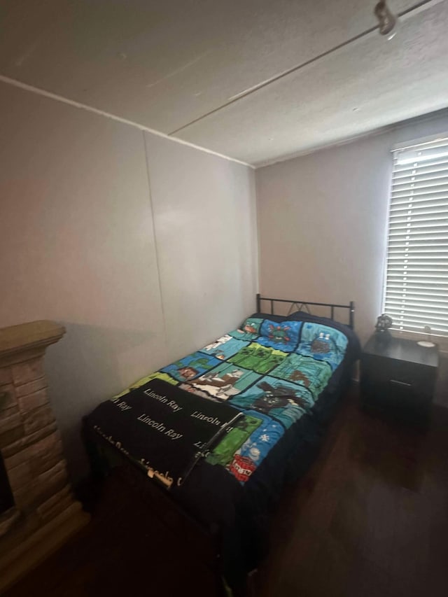 bedroom with hardwood / wood-style flooring and a textured ceiling