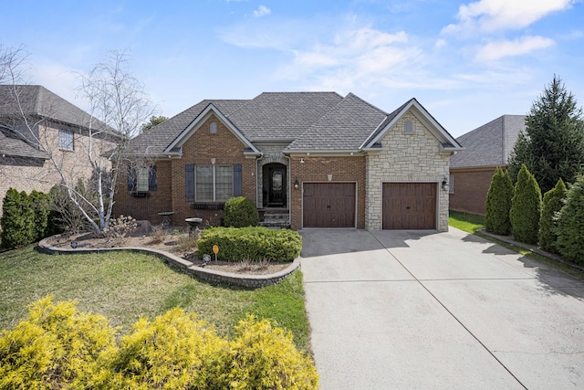 view of front facade with an attached garage, brick siding, a shingled roof, driveway, and a front lawn