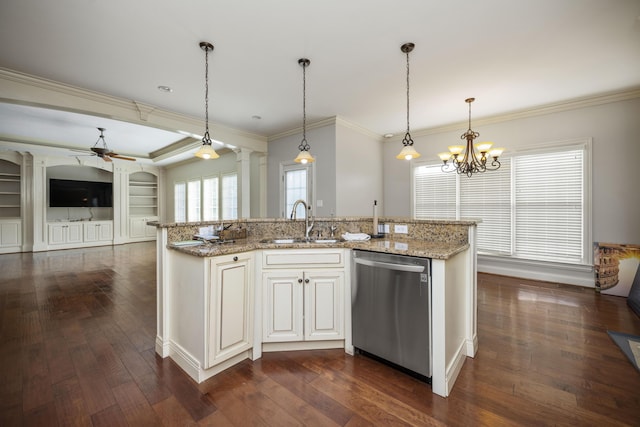 kitchen featuring stainless steel dishwasher, open floor plan, a sink, ornate columns, and ceiling fan with notable chandelier