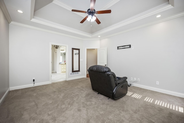 living area featuring baseboards, visible vents, a tray ceiling, crown molding, and carpet flooring