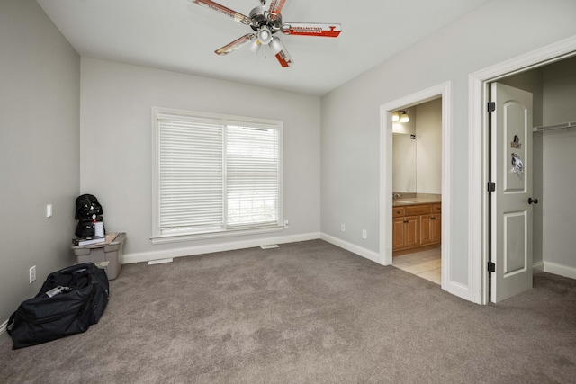 unfurnished bedroom featuring carpet flooring, baseboards, and ensuite bathroom