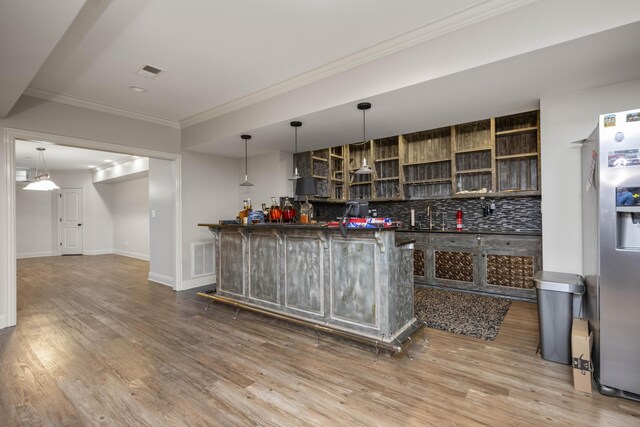 unfurnished living room with ornamental molding, wood finished floors, decorative columns, and recessed lighting