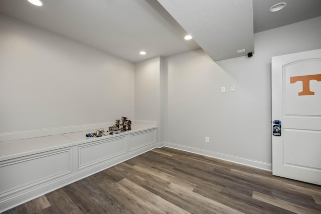 interior space featuring baseboards, dark wood-style flooring, and recessed lighting