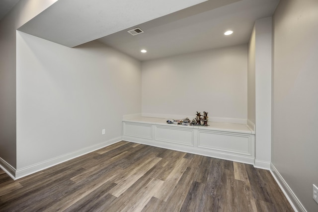 interior space with baseboards, visible vents, dark wood finished floors, and recessed lighting