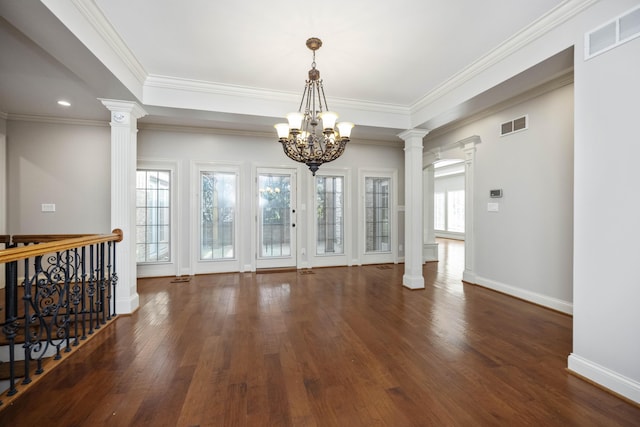 interior space with decorative columns, visible vents, a chandelier, and hardwood / wood-style floors