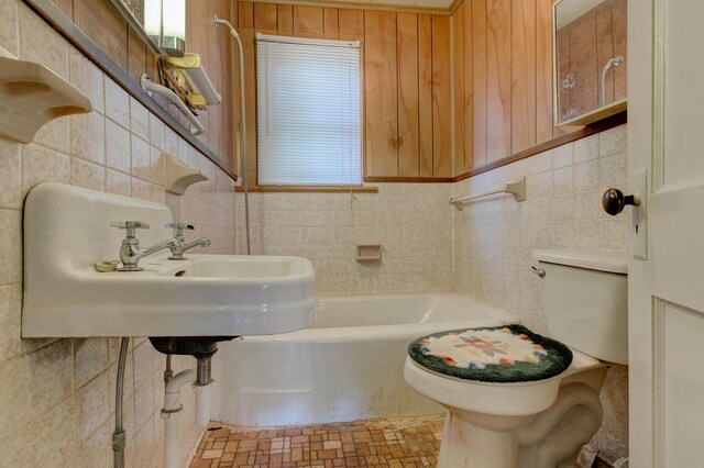 bathroom with tile walls, toilet, and decorative backsplash