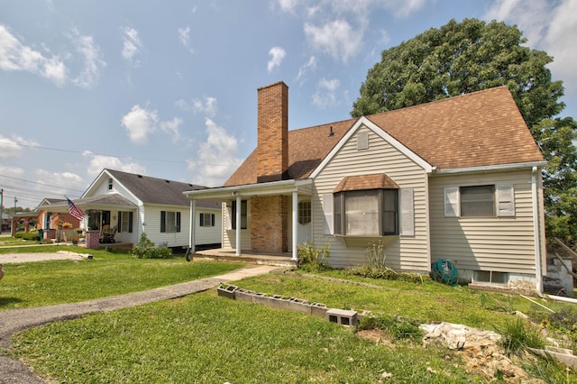 view of front of home featuring covered porch and a front lawn