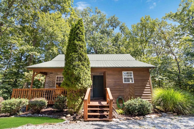 view of front of house featuring metal roof and stone siding