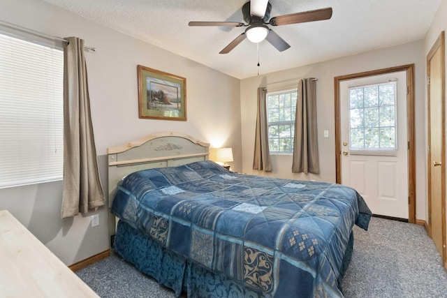 bedroom featuring ceiling fan, baseboards, carpet floors, and a textured ceiling