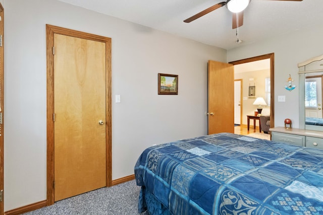 carpeted bedroom featuring baseboards and ceiling fan