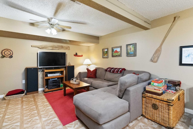 living room with baseboards, visible vents, a textured ceiling, and a ceiling fan