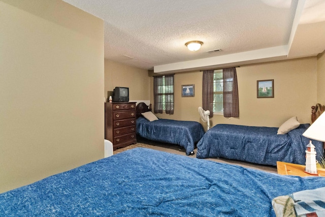 bedroom featuring visible vents and a textured ceiling