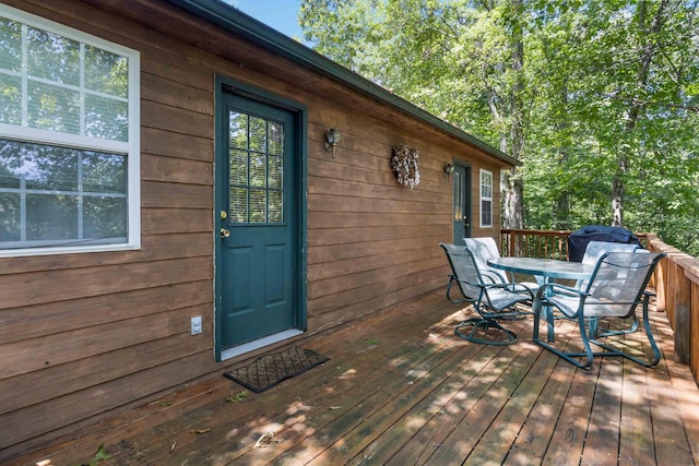 wooden deck featuring outdoor dining area