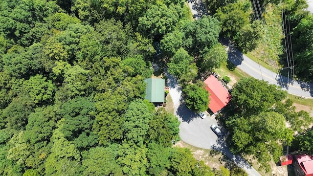 birds eye view of property with a view of trees