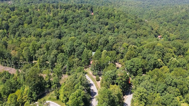 drone / aerial view with a wooded view