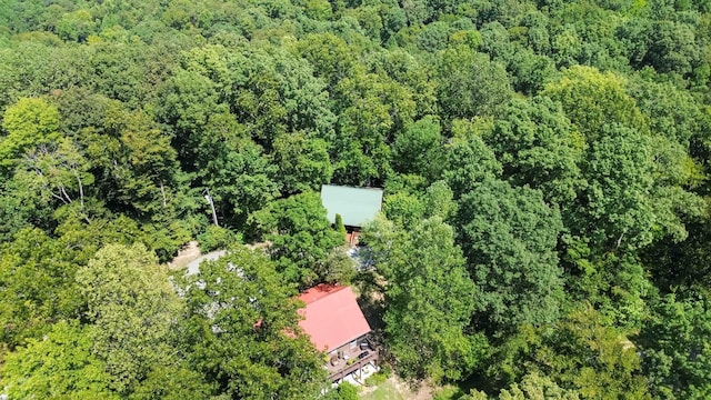 birds eye view of property featuring a view of trees