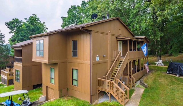 exterior space featuring stairway, a yard, and an attached garage