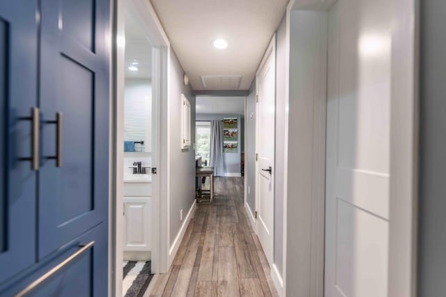 corridor with light hardwood / wood-style floors