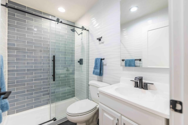 bathroom with an enclosed shower, tile walls, toilet, and vanity