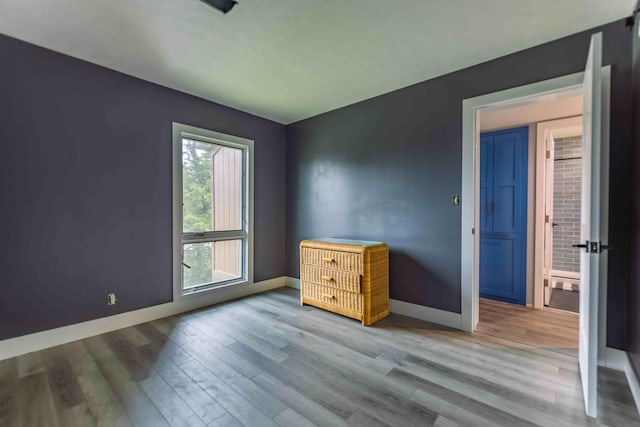 unfurnished bedroom with hardwood / wood-style flooring